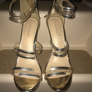 Brand new. Never worn.Gold and clear sandals.